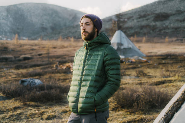 Young Caucasian man standing near teepee in Mongolia in winter
